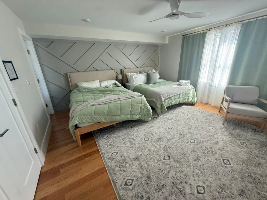 Airbnb bedroom with two queen beds before AMH turnover staging