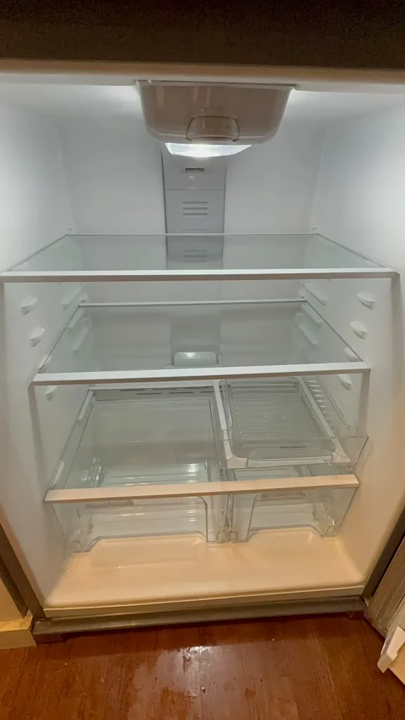Same refrigerator after AMH cleaning, with clean white interior and shelves and drawers back in place